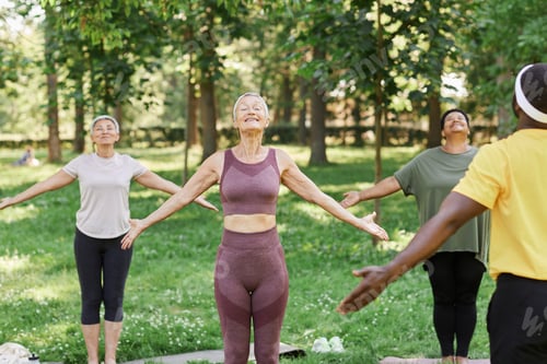 Preview: Group Doing Yoga in Park on Sunny Day