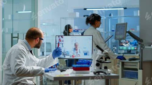 Preview: Male chemist listening professional doctor on video call