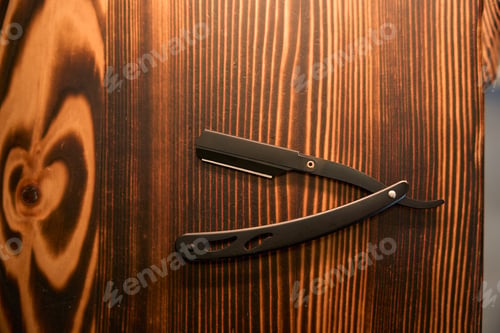 Preview: Vintage barber shop razor on wooden background with copy space