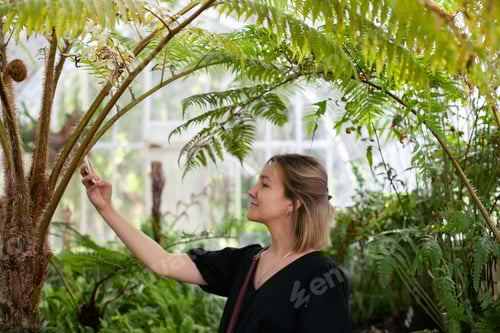 Preview: Young woman using mobile phone to take pictures or video chat, candid millennial lifestyle, gen z