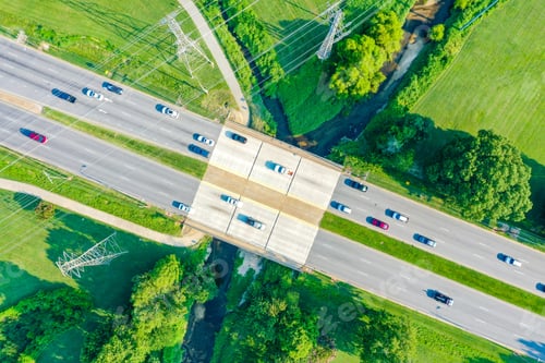 Preview: Aerial view of a bridge over the creek and powerlines with cars on the road