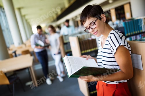 Preview: Woman reading a book at the library