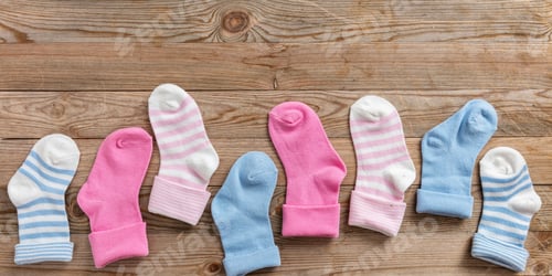 Preview: Baby boy and girl socks on wooden background