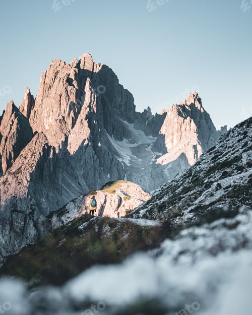 Preview: Landscape of Prags Dolomites with grass fields under dolomites mountains with gray sky