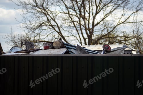 Preview: Pile of scrap metal in the backyard in a neat tank. Metal recycling. Second life to things. Caring f