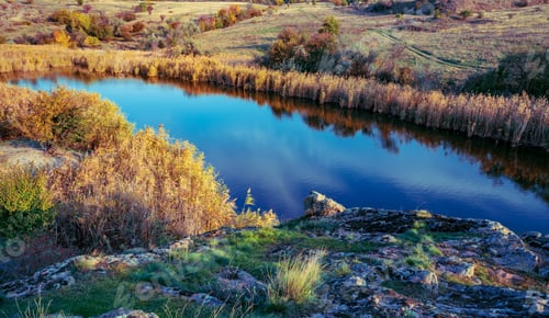 Preview: Beautiful small river among large stones and green vegetation on the hills in Ukraine