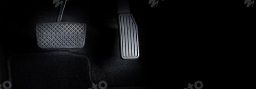 Preview: Man foot and accelerator and brake pedal inside the car or vehicle and copy space