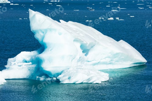Preview: Small Iceberg floating in pure blue Ocean melting