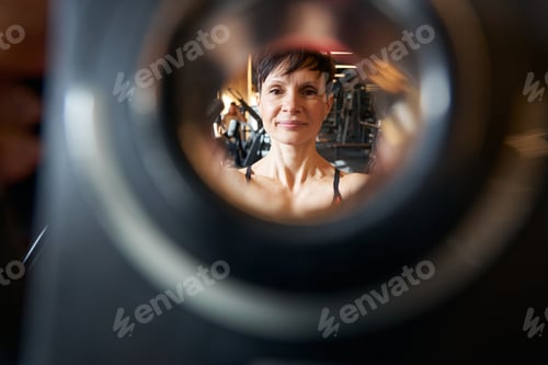 Preview: Woman using gym equipment during strength workout