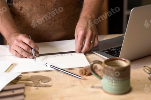 Preview: Carpenter at his workshop, close up view of hand drawing