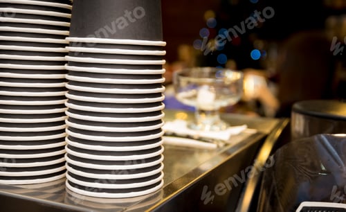 Preview: Stack of a paper cups on the top of a coffee machine