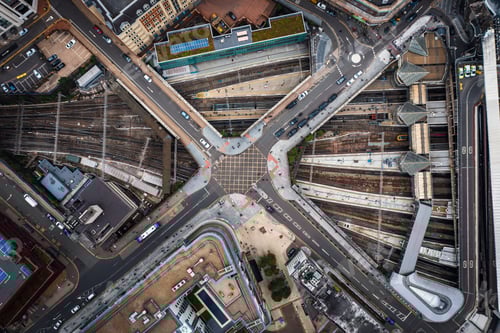 Preview: Aerial view of road and street bridges going over railway tracks in a busy city conurbation