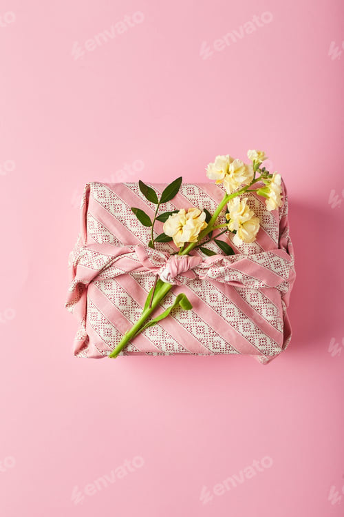 Preview: Bouquet of yellow matthiola with gift wrap in traditional japanese furoshiki style. Design concept