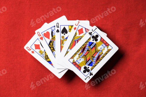 Preview: top view of red poker table and unfolded playing cards combination with different suits