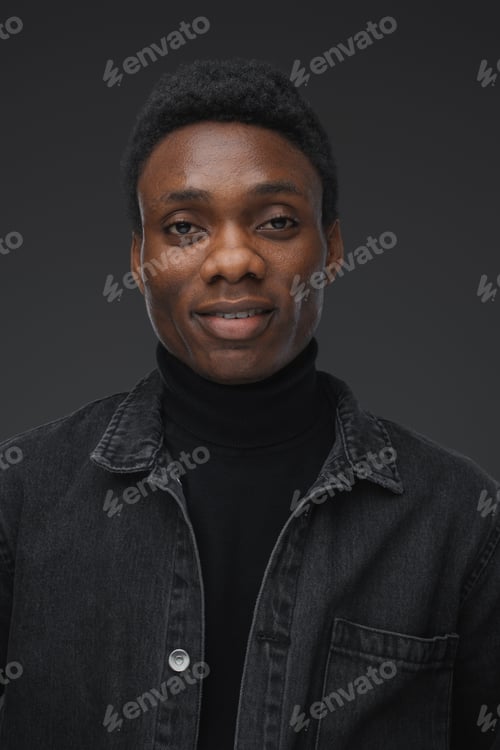 Preview: Trendy african man looking at camera against grey background