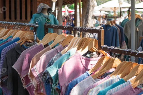 Preview: Clothes racks with cotton dresses on hangers. Showcase with clothes on local street local market.
