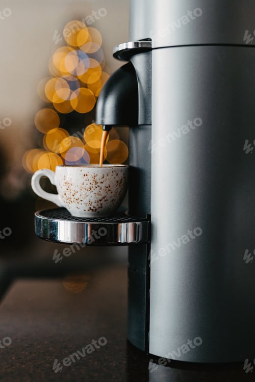 Preview: Preparing espresso with a coffee machine. Brewing coffee at home. Cup of coffee close-up.