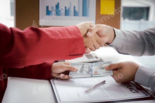 Preview: Bribery and corruption concept, Businessman and businesswoman making handshake with money in hands