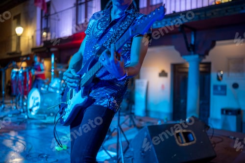 Preview: Rock and roll group performing live at night