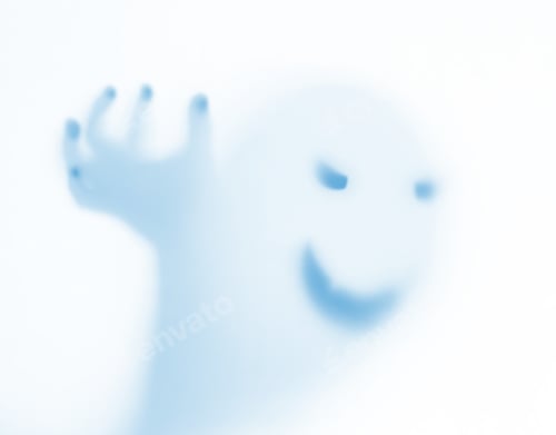 Preview: Halloween blurred background. A ghost resembling a pumpkin in color behind glass