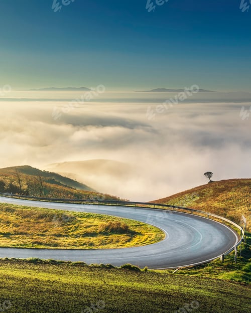 Preview: Road with hairpin bend in the Tuscan landscape near Volterra on a foggy morning