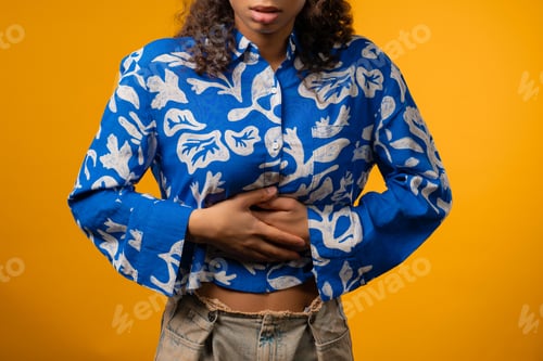 Preview: Teenager girl squeezing belly with hands. abdominal pain, suffering stomach ache