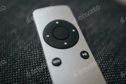 Preview: Selective focus shot of remote control of TV on a black background.