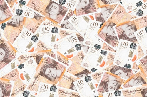 Preview: 10 British pounds bills lies in big pile. Rich life conceptual background