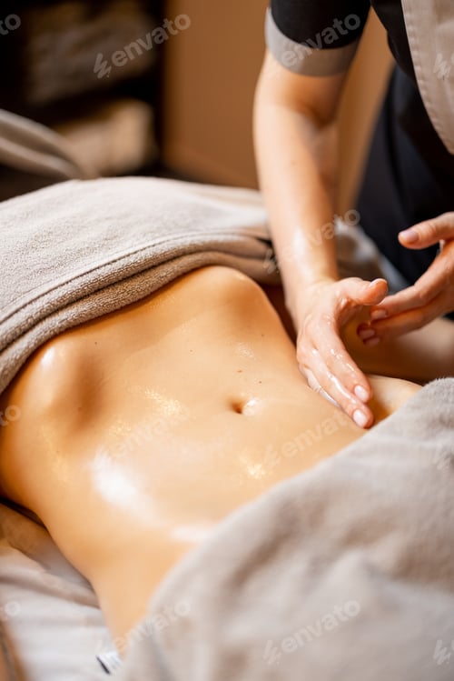 Preview: Masseuse performs professional abdominal massage for a woman