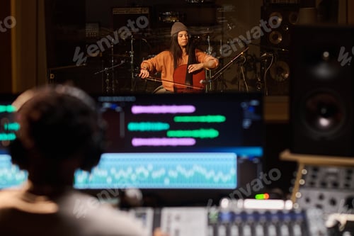 Preview: Young Adult Latin Woman Playing Cello in Recording Studio during Music Session