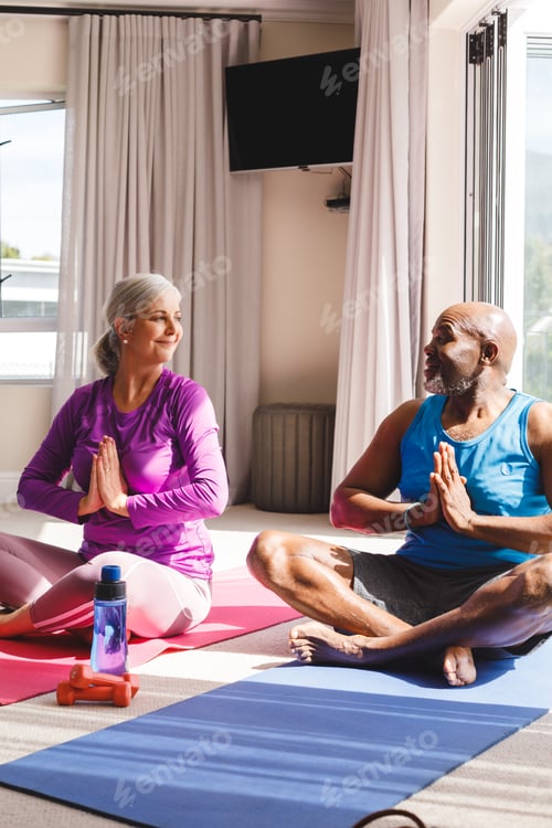 Preview: Happy senior diverse couple practicing yoga and talking
