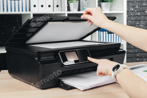 Preview: Woman making photocopy using copier in office