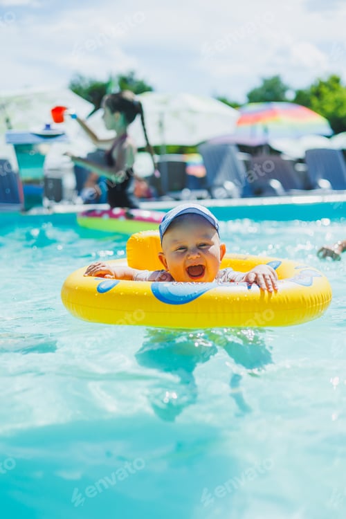 Preview: A one-year-old little boy swims in an inflatable circle in the pool. Children's pool.