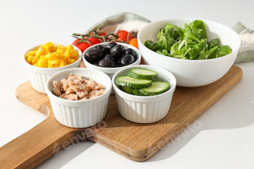 Preview: Cooking salad with tuna on a light background.