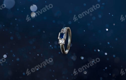 Preview: Closeup shot of a ring with a blue stone on an abstract background