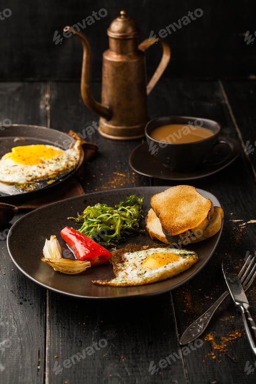 Preview: Fried eggs with toast and coffee on a dark background.