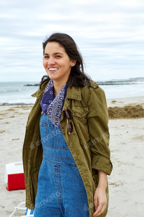 Preview: Portrait of smiling young woman on beach