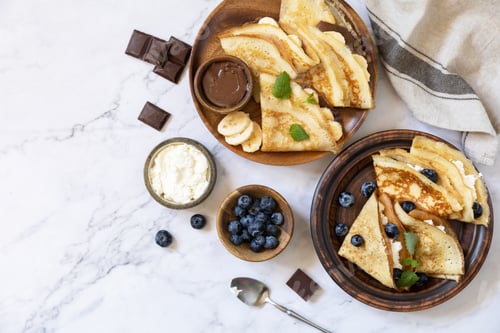 Preview: Delicious homemade crepes with chocolate caramel, bananas and blueberries and ricotta.