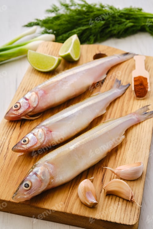 Preview: Raw fresh smelt fish on wooden board