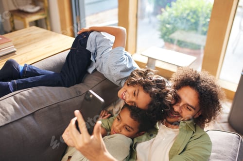 Preview: Father and sons taking selfie on phone