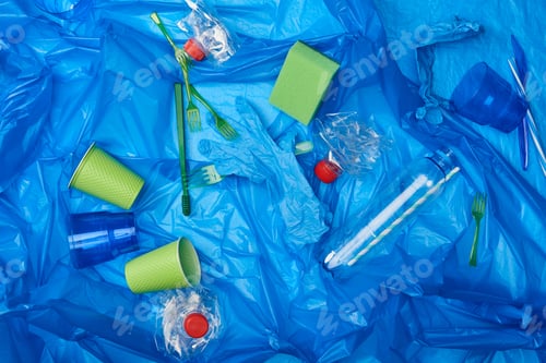 Preview: top view of blue crumpled polyethylene bag with plastic bottles, disposable tableware ang sponge