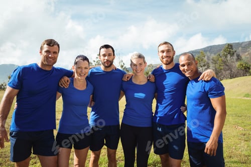 Preview: Group of people standing with arms around each other during boot camp training