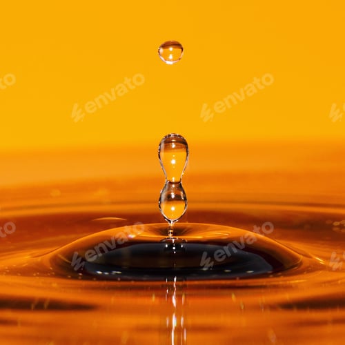 Preview: Close up of a water drop on a orange background