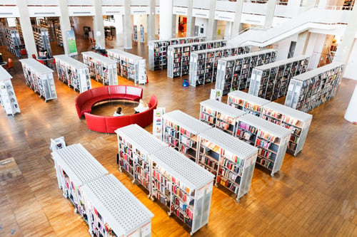 Preview: High angle view of women sitting on sofa in library