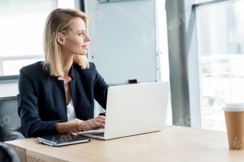 Woman Working at Laptop in Bright Modern Office
