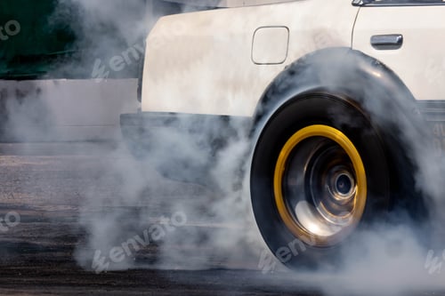 Preview: Car burnout wheels tire with white smoke,Car wheel burnout with smoke from the spinning tyre.