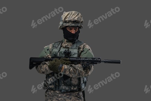 Preview: Modern serviceman with rifle posing against gray background