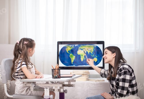 Preview: A mother with a child sits at the table and does homework. The child learns at home. Home schooling.