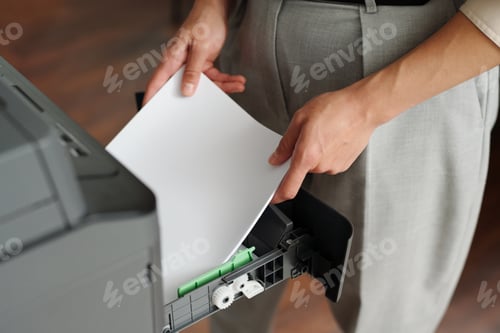 Preview: Close-up of young businesswoman in smart casualwear putting papers into tray