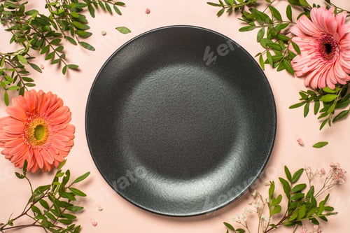 Preview: Table setting with plate and flowers top view.